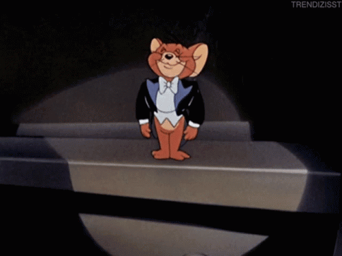 A Cartoon Of Jerry Wearing A Tuxedo And Bow Tie Is Standing On A Stage GIF