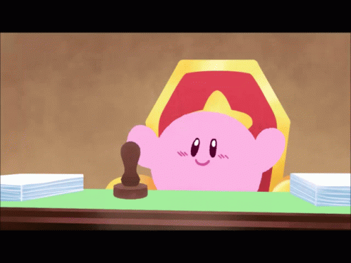 A Cartoon Of Kirby Sitting At A Desk With A Stamp GIF