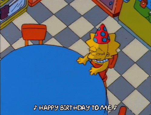 A Cartoon Of Lisa Simpson Sitting At A Table With The Words Happy Birthday To Me Below Her GIF