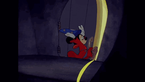 a cartoon of mickey mouse wearing a wizard costume