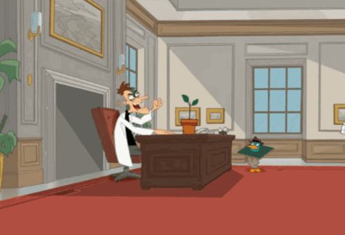 A Cartoon Of Perry The Platypus Sitting At A Desk With A Plant GIF