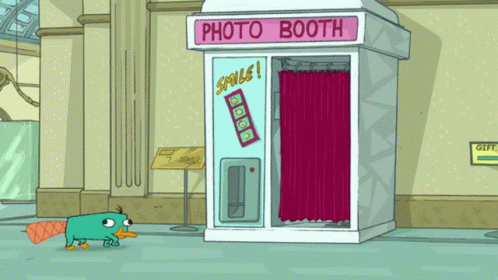 A Cartoon Of Perry The Platypus Standing In Front Of A Photo Booth In A Museum GIF