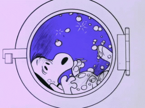 A Cartoon Of Snoopy Laying In A Washing Machine . GIF
