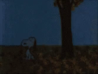 A Cartoon Of Snoopy Sitting In A Pile Of Leaves Under A Tree GIF