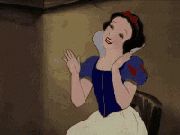 A Cartoon Of Snow White Is Sitting In A Chair And Smiling . GIF