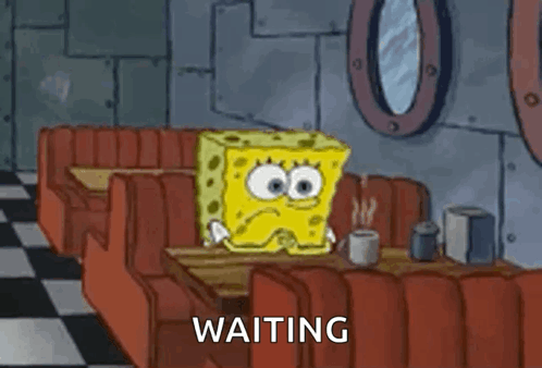 A Cartoon Of Spongebob Squarepants Sitting At A Table In A Diner . GIF