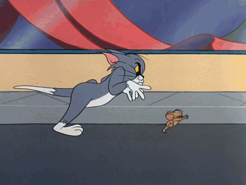 A Cartoon Of Tom And Jerry Playing With Each Other On A Sidewalk GIF