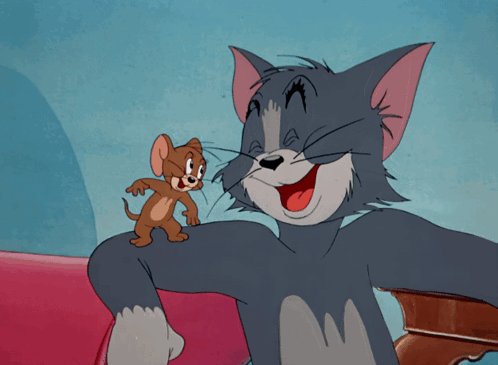 A Cartoon Of Tom And Jerry Sitting On A Red Couch GIF