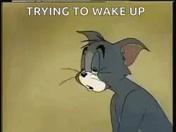 A Cartoon Of Tom Trying To Wake Up With The Words Trying To Wake Up Below Him . GIF