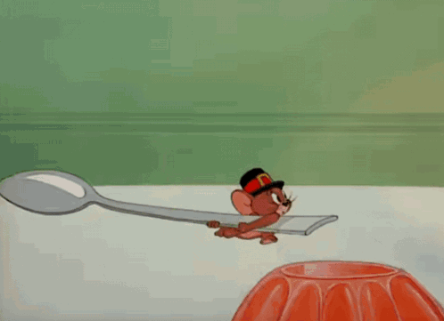 A Cartoon Of Tom Wearing A Feathered Headdress GIF