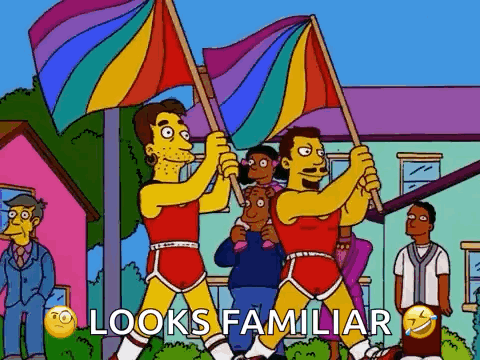 A Cartoon Of Two Men Holding Rainbow Flags With The Words Looks Familiar Below Them . GIF