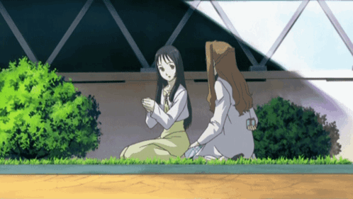 A Cartoon Of Two Women Sitting On The Grass Talking GIF