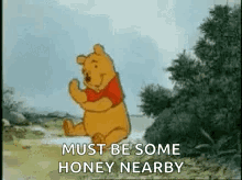 A Cartoon Of Winnie The Pooh Dancing In A Field With The Words `` Must Be Some Honey Nearby '' . GIF