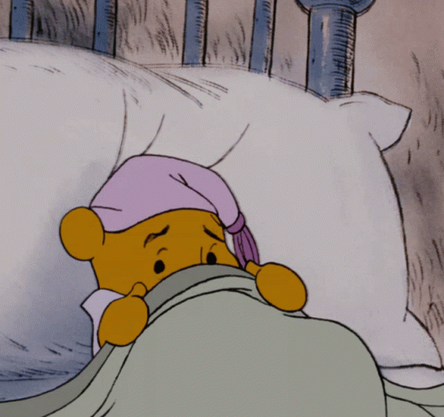A Cartoon Of Winnie The Pooh Laying In Bed With A Purple Hat On GIF