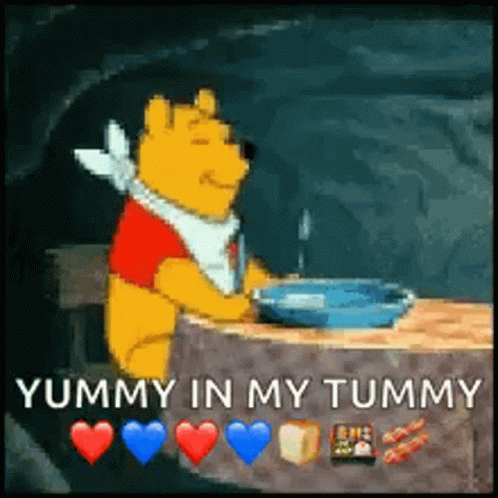 A Cartoon Of Winnie The Pooh Sitting At A Table With A Bowl Of Food In His Hand . GIF
