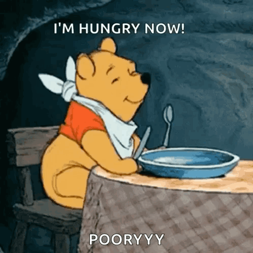 A Cartoon Of Winnie The Pooh Sitting At A Table With A Plate Of Food And A Spoon . GIF