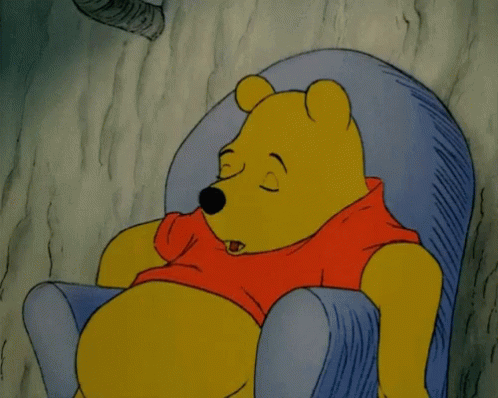 A Cartoon Of Winnie The Pooh Sleeping In A Chair With His Eyes Closed GIF