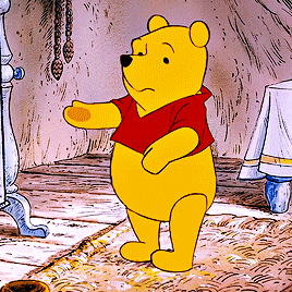 a cartoon of winnie the pooh standing on a rug in a room