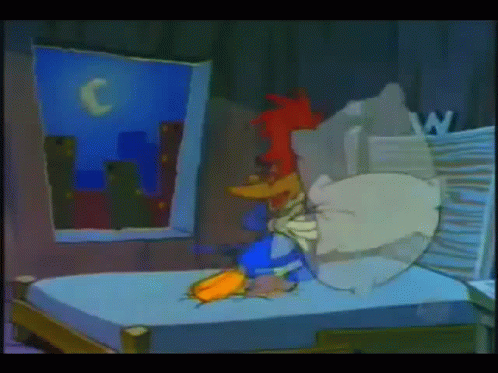 a cartoon of woody woodpecker laying on a bed in a dark room