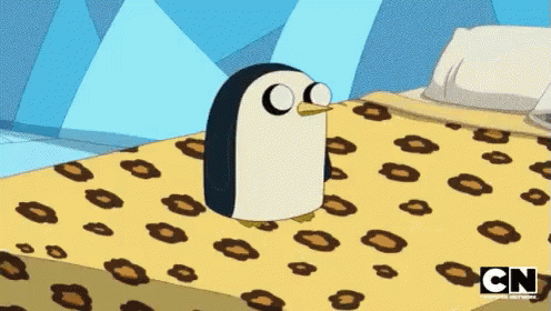 A Cartoon Penguin Is Sitting On A Bed With A Cn Logo On The Bottom GIF