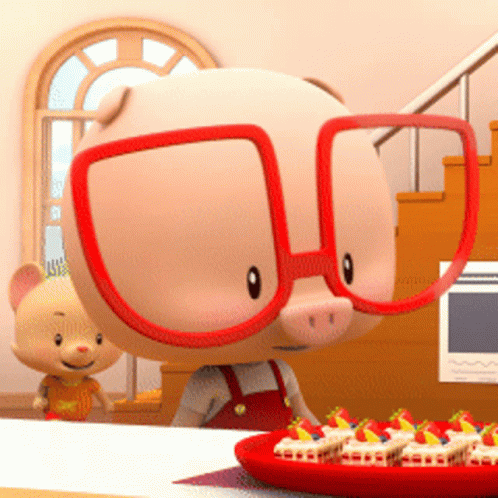 A Cartoon Pig Wearing Red Glasses Is Standing Next To A Plate Of Cupcakes GIF