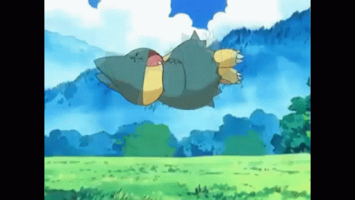 A Cartoon Pokemon Is Flying Through The Air Over A Grassy Field . GIF