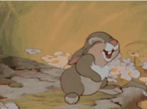 A Cartoon Rabbit Is Laughing And Covering Its Face With Its Paws GIF