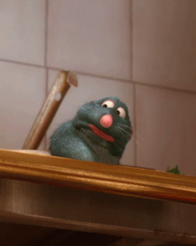A Cartoon Rat With A Pink Nose Is Sitting On A Counter GIF