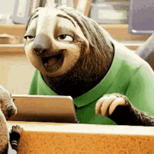 A Cartoon Sloth Wearing A Green Shirt Is Sitting At A Table . GIF