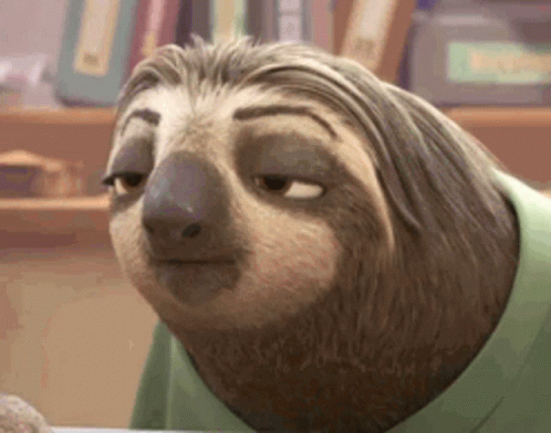 A Cartoon Sloth Wearing A Green Shirt Is Sitting At A Table . GIF