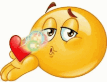 A Cartoon Smiley Face Is Blowing A Kiss While Holding A Red Heart . GIF