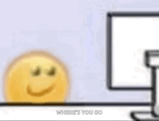 A Cartoon Smiley Face Is Sitting In Front Of A Computer Screen . GIF
