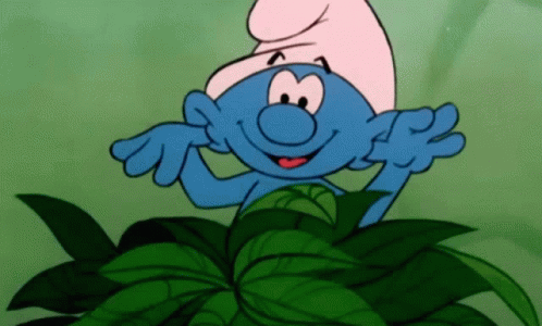 A Cartoon Smurf Is Standing In A Pile Of Leaves . GIF