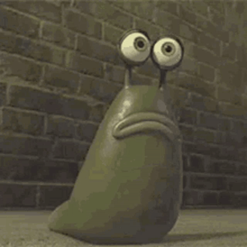 A Cartoon Snail With Big Eyes Is Sitting In Front Of A Brick Wall . GIF