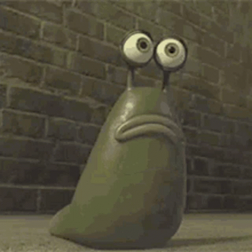 A Cartoon Snail With Big Eyes Is Sitting In Front Of A Brick Wall . GIF