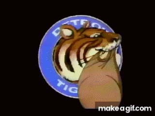 A Cartoon Tiger Is Holding A Sign That Says Detroit Tigers On It GIF