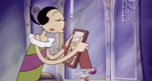 A Cartoon Woman Is Holding A Framed Picture Of Herself . GIF