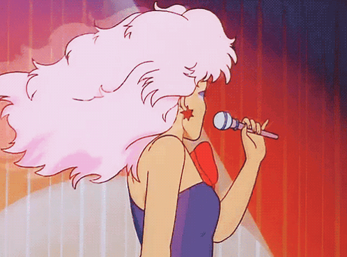 A Cartoon Woman Singing Into A Microphone With Pink Hair GIF