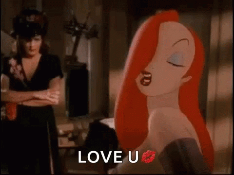 A Cartoon Woman With Red Hair And A Kiss On Her Lips Is Standing Next To A Woman With Her Arms Crossed . GIF