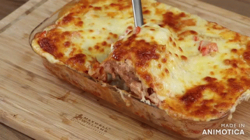 A Casserole Dish With A Spoon In It Is Made By Maxwell Williams GIF