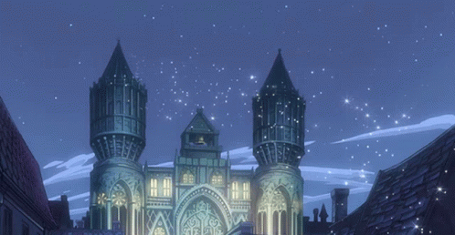 A Castle Is Lit Up At Night With A Blue Sky Behind It GIF