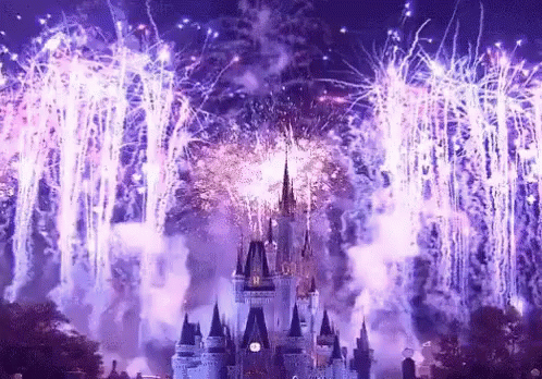 A Castle Is Surrounded By Purple Fireworks And Smoke GIF