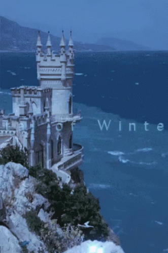 A Castle On A Cliff Overlooking The Ocean With The Words Capital Of Winteress GIF