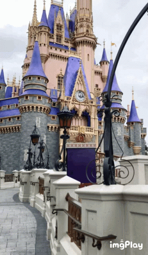 A Castle With A Clock On The Top Of It And A Sign That Says Imgplay GIF