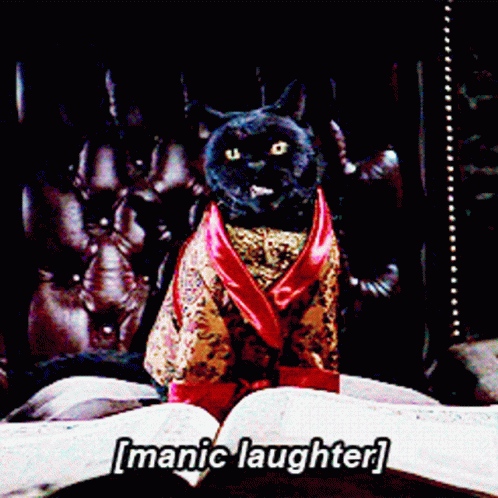 A Cat In A Robe Is Sitting On A Bed With The Words [ Manic Laughter ] Written Above It GIF