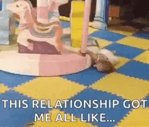 A Cat Is Laying On A Checkered Floor Next To A Carousel And Says `` This Relationship Got Me All Like ... '' . GIF