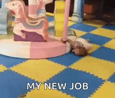 A Cat Is Laying On A Checkered Floor Next To A Pink Rocking Horse And The Words My New Job GIF