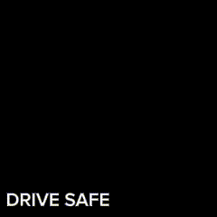 A Cat Is Looking At A Steering Wheel With The Words Drive Safe Written Below It GIF