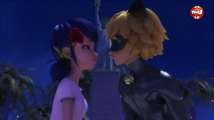 A Cat Noir And A Ladybug Are Kissing In Front Of A Statue Of Liberty . GIF