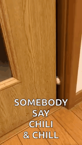 A Cat Peeking Out Of A Wooden Door With The Words Somebody Say Chili & Chill GIF